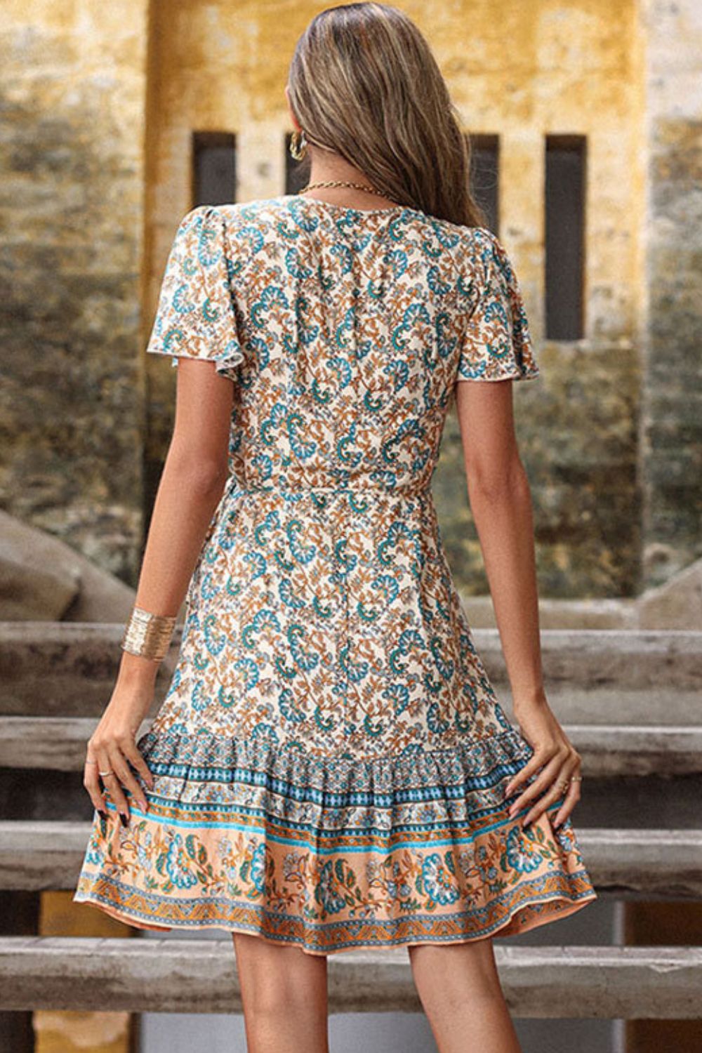 A Bohemian Flutter Sleeve Surplice Dress