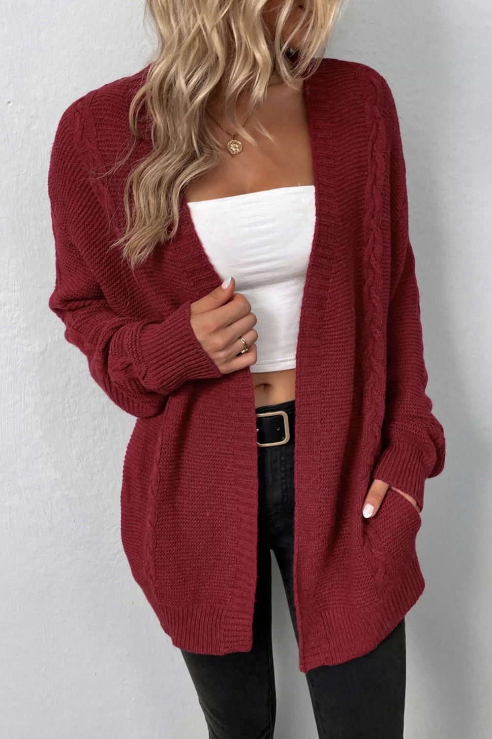 A Cable-Knit Open Front Cardigan with Pockets